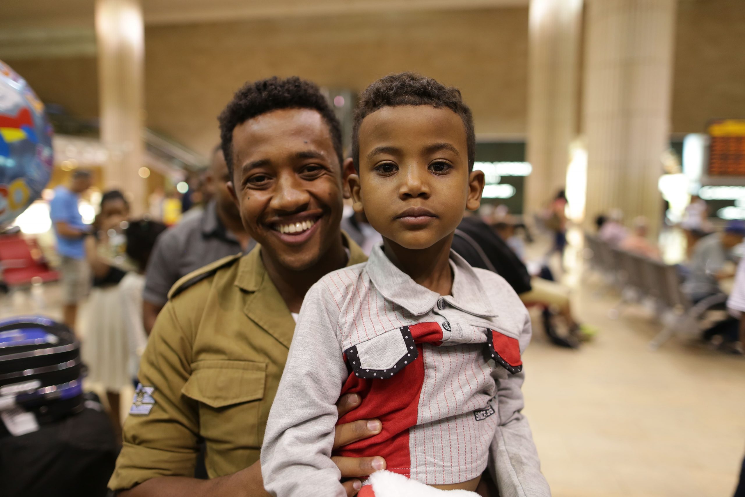 Ethiopians smile as they reunite with family upon landing in Israel