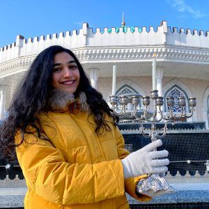 A Jewish Agency Israeli emissary serving in Uzbekistan lights Hanukkah candles