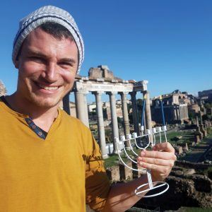 A Jewish Agency Israeli emissary serving in Rome lights Hanukkah candles