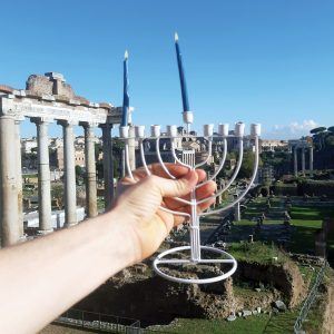 A Jewish Agency Israeli emissary serving in Rome lights Hanukkah candles