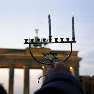 A Jewish Agency Israeli emissary in Berlin lights Hanukkah candles
