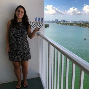 A Jewish Agency Israeli emissary serving in Miami, Florida, lights Hanukkah candles