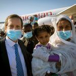 Jewish Agency Chairman Isaac Herzog with new Ethiopian olim (Credit: Olivier Fitoussi, courtesy of The Jewish Agency for Israel)