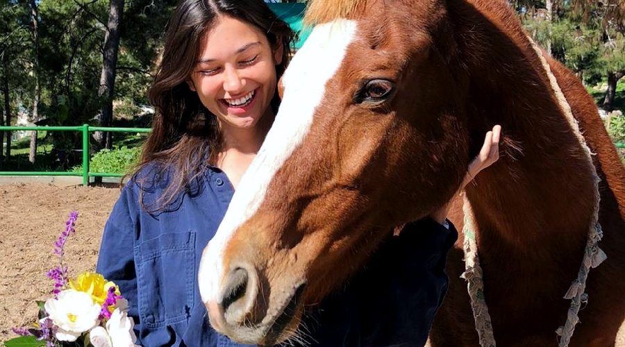 Annamarie with a horse on the kibbutz