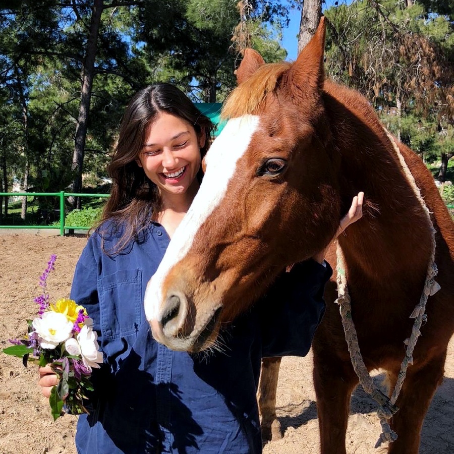 Annamarie with a horse on the kibbutz