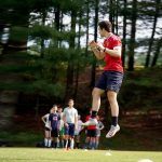 A counselor teaching the campers how to jump in soccer. Credit: Mai Siegel