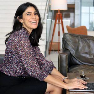 Sarah, a SparkIL borrower in Israel, sitting at a laptop