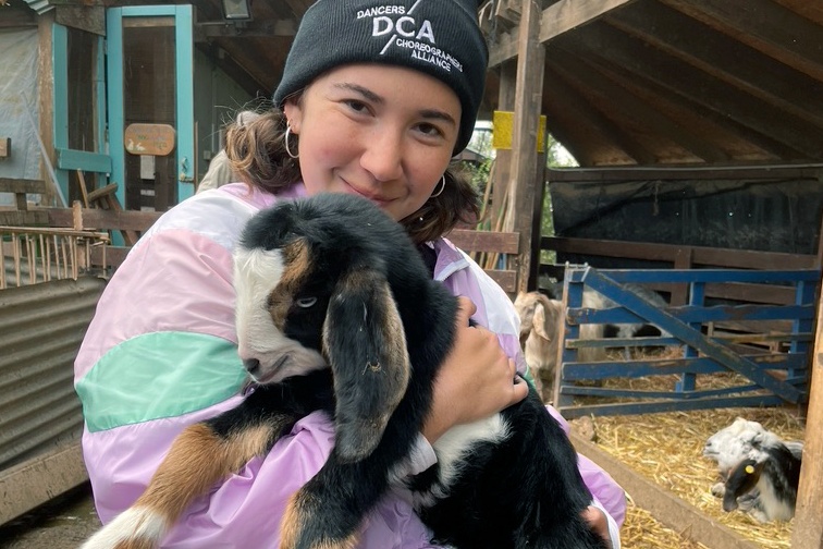Sylvia with a baby goat on the Kibbutz at Project TEN