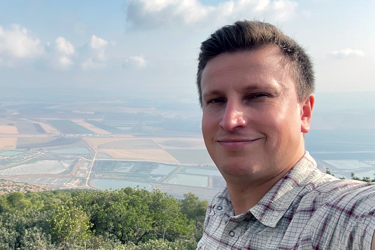 Maxim, a Russian immigrant, taking a selfie on a scenic overlook in Israel