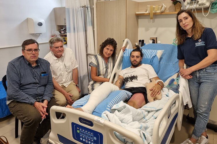 Guy in the hospital with family members