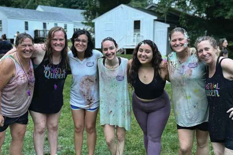Daria (middle) with other camp staff after a messy outdoor activity