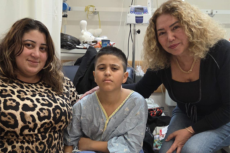 Amir, his mom, and a Jewish Agency representative in the hospital