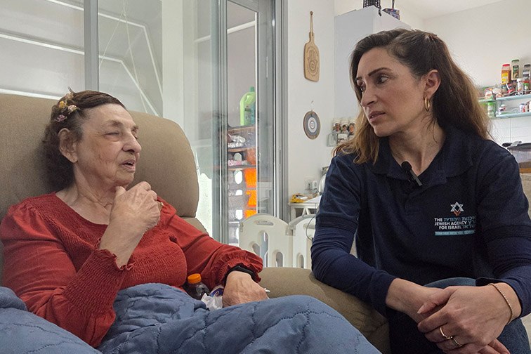 Sandra in the hospital with a Jewish Agency representative