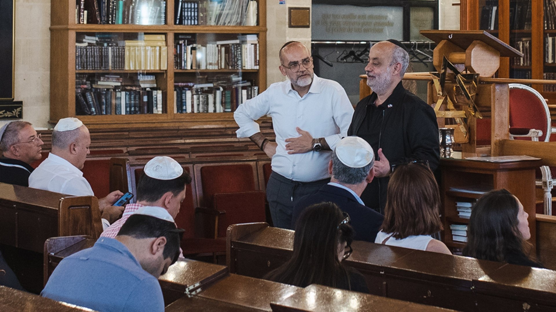 Members of a Jewish community gathering inside a synagogue